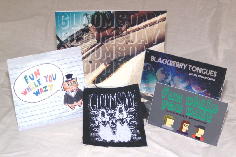 Grrl on Grrl merch contest package A, 2016: Blackberry Tongues - We Are Open Mouths CD, Fun While You Wait self-titled CD & sticker, Gloomsday - Sunburn Sessions 7" & patch
