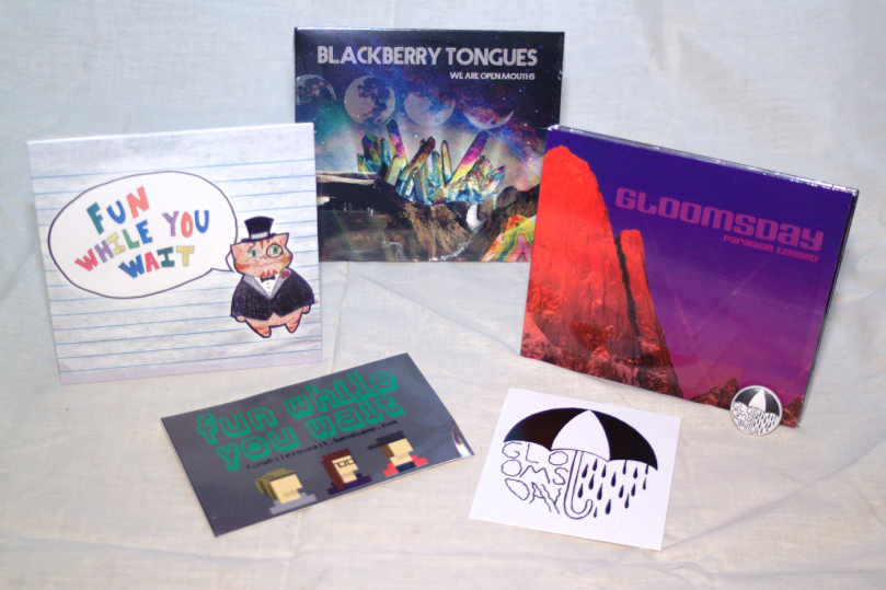 Grrl on Grrl merch contest package B, 2016: Blackberry Tongues - We Are Open Mouths CD, Fun While You Wait self-titled EP & sticker, Gloomsday - Paradise Tossed CD, sticker, & button
